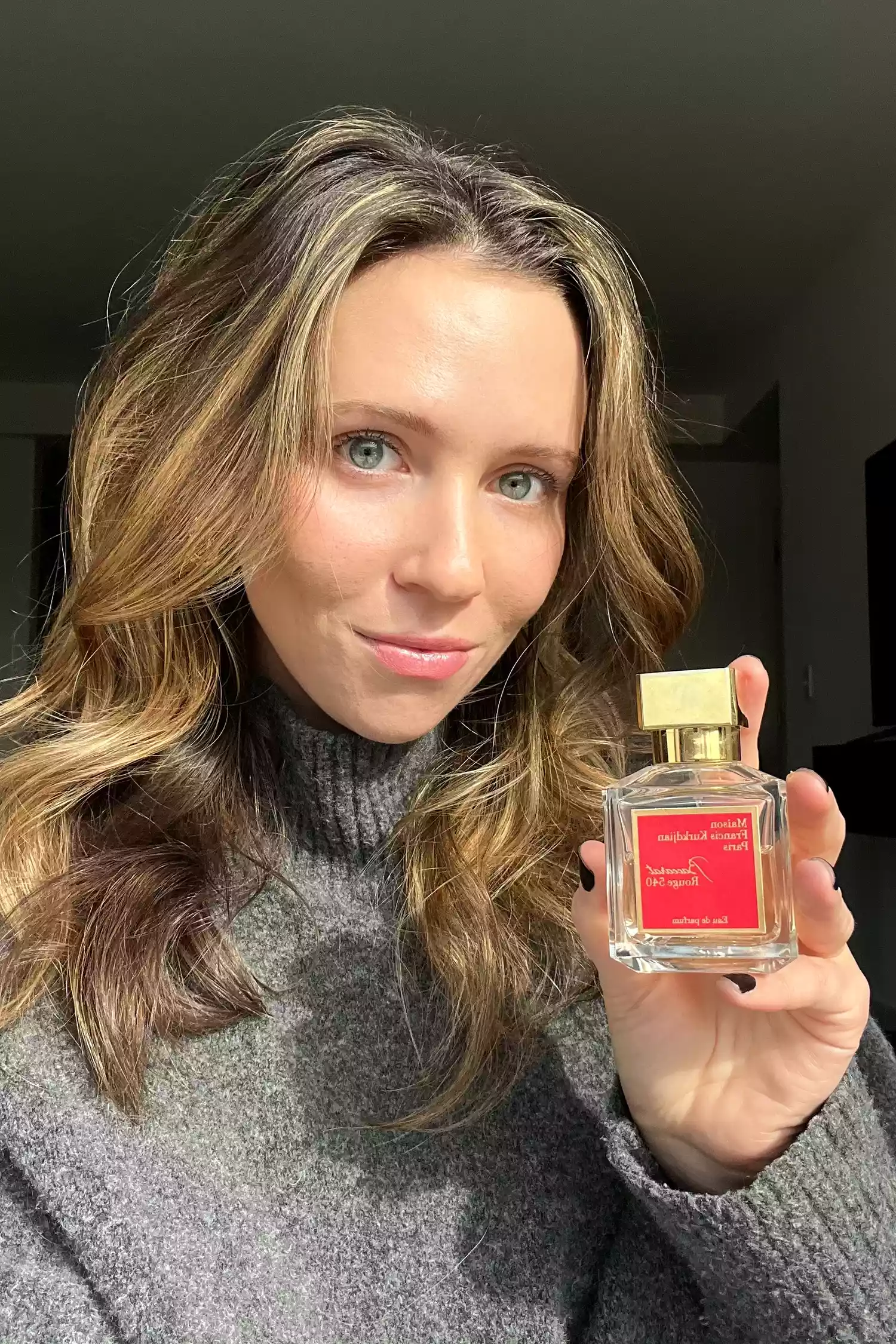 A person holding the Baccarat Rouge 540 eau de parfum