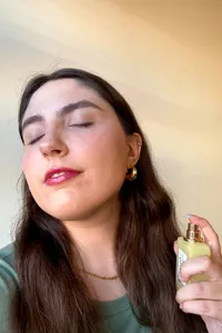 A person spraying Ellis Brooklyn Sweet